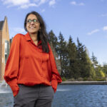 Anjum Hajat standing in front of a fountain.