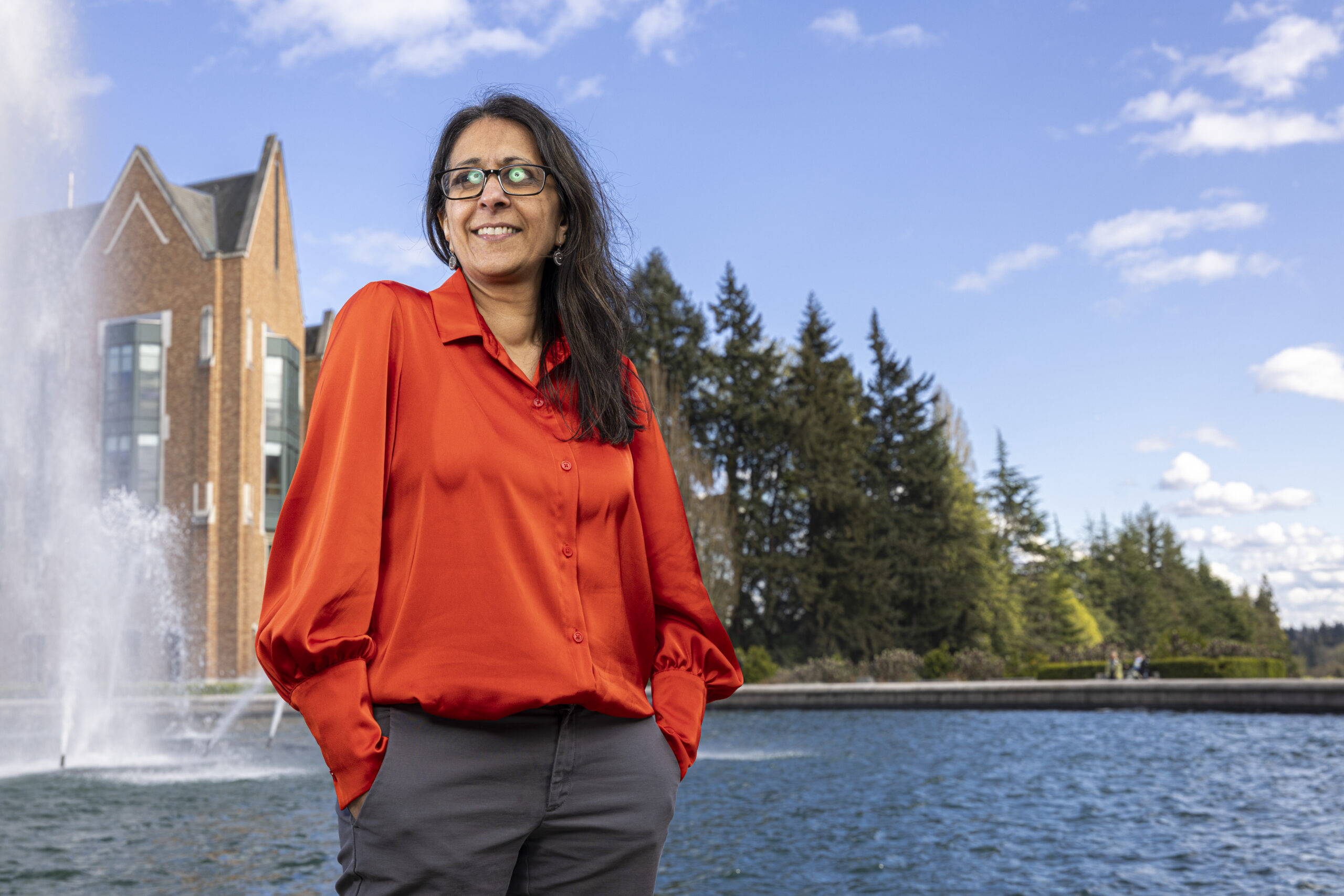 Anjum Hajat standing in front of a fountain.