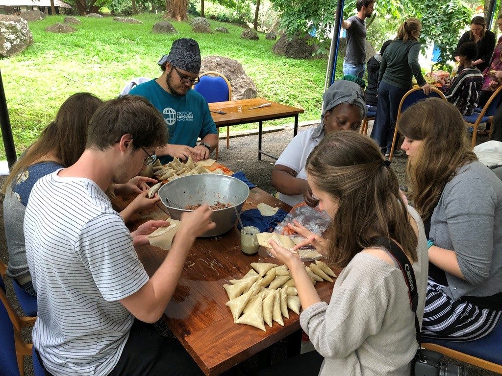 Photo of students learning to prepare Tanzanian sambusas