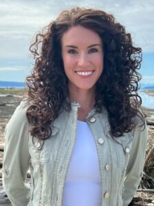 Stephanie Mitchell, outside, wearing a tan jacket.